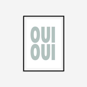 May include: A framed print with the word "OUI" repeated twice in a light blue color against a white background.
