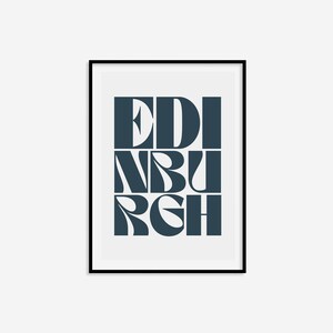 May include: A framed print with the word "EDINBURGH" in a bold, stylized font. The letters are in a dark blue color against a white background.