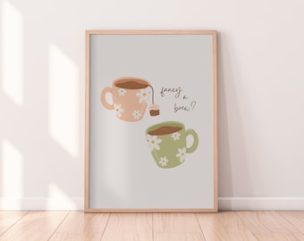 May include: A printable art print with two mugs of tea, one pink and one green, with white flowers. The text reads "fancy a brew?"