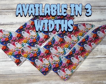May include: Three triangular fabric bandanas featuring a repeating pattern of white ghosts and colourful embroidered-style flowers on a dark blue background. The text "AVAILABLE IN 3 WIDTHS" is printed in large, light blue letters across the top.