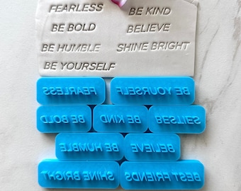 May include: Blue rubber stamps with positive messages such as "Be Kind", "Believe", "Shine Bright", "Be Yourself", "Fearless", "Be Bold", "Be Humble", and "Best Friends".