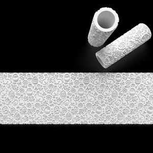 May include: White rolling pin with an Easter-themed embossed design featuring bunnies, eggs, and flowers. The image also shows a section of the embossed pattern. Ideal for creating Easter biscuits and baked goods.