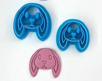 May include: Three bunny-shaped cookie cutters, two are blue and one is pink. The cutters are made of plastic and have a detailed design.