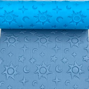 May include: A blue rolling pin with a sun, moon, and star pattern. The rolling pin is used to create an embossed design on fondant or clay.