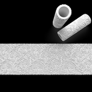 May include: White textured paint rollers with a floral and tree design, alongside a matching embossed pattern. The rollers are cylindrical, and the pattern is repeated on a white surface. The image is set against a black background.