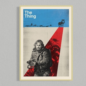 May include: A vintage movie poster for the film "The Thing" featuring a man holding a weapon and a dog in the background. The poster has a red, white, and blue color scheme.