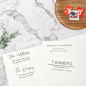 May include: Four white address labels with black text. The labels are for "The Whites", "The Knopes", "Monica & Chandler", and "Tanners". Each label includes the recipient's name, street address, city, state, and zip code.