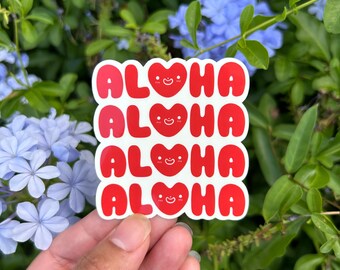 May include: Four red stickers with the word "ALOHA" in white letters and a red heart with a smiley face in the middle of each word.