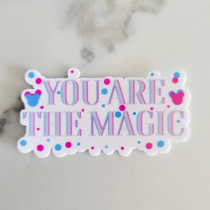 May include: White sticker with pink and blue polka dots and the text "YOU ARE THE MAGIC" in a pink and blue font.