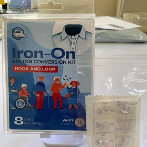 May include: An Iron-On Button Conversion Kit with Hook and Loop closure. The package includes 8 white buttons, each 11.4 mm in diameter. The packaging features an illustration of a shirt and people.