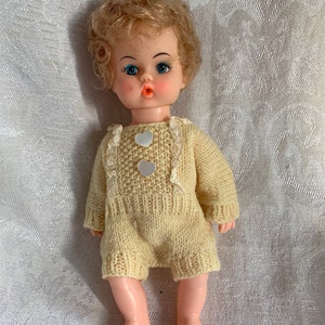 Vintage mid century modern hard plastic doll made in Hong Kong 8.5” tall. Wearing one piece sweater outfit. In good vintage condition with l