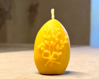Candle made of beeswax in egg shape with willow combs