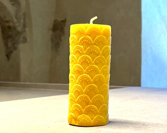 Decorative candle with ornaments made of beeswax