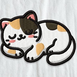 May include: Embroidered patch of a sleeping cat. The cat is white with patches of brown, tan, and black. It has closed eyes, pink cheeks, and a black outline. The patch is on a white fabric background.