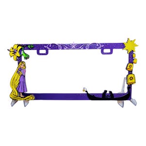 May include: Purple license plate frame featuring a cartoon princess with long blonde hair and a purple dress. The frame has a gondola, lanterns, and a yellow flower design. The frame is approximately 30 cm wide and 15 cm tall.