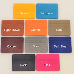 May include: Ten different colored card holders, each with a different color and a label with the color name. The colors are: Yellow, Turquoise, Light Brown, Orange, Sand, Coffee, Grey, Dark Blue, Black, and Pink.