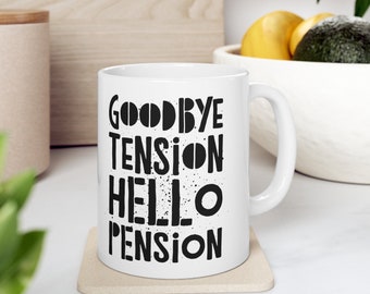 May include: White ceramic coffee mug with black text that reads "Goodbye Tension Hello Pension".