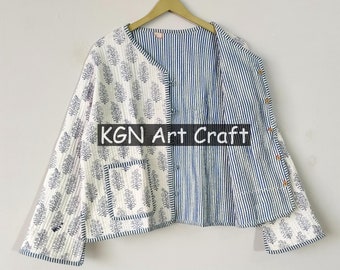 May include: A white and blue quilted jacket with a floral print on one side and a striped pattern on the other. The jacket has a pocket on the floral side and is hanging on a wooden hanger. The text "KGN Art Craft" is visible on the jacket.