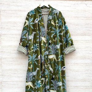 May include: A long green velvet robe with a jungle print featuring zebras, leopards, toucans, and palm trees. The robe has a striped lining and a shawl collar.
