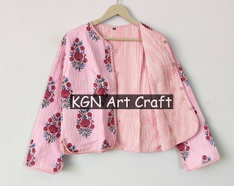 May include: A pink and white cotton jacket with a floral print and striped fabric. The jacket has a button closure and a relaxed fit. KGN Art Craft is printed on the front of the jacket.