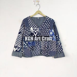 May include: A blue and white patterned cotton jacket with a V-neck and long sleeves. The jacket is made of patchwork fabric and has a button closure. The text "KGN Art Craft" is visible on the front of the jacket.