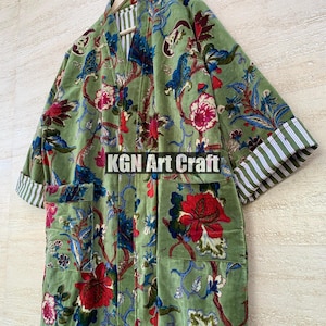 May include: A green velvet robe with a floral print and striped trim. The robe has a collar and two pockets. The text "KGN Art Craft" is visible on the robe.