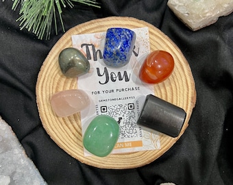 May include: A wooden round tray with six tumbled stones, including green, blue, red, pink, and grey. The tray has a thank you note with the text "Thank you for your purchase" and a QR code.