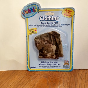 May include: Webkinz Clothing Camo Cargo Pant for dogs and cats. This item fits most Webkinz dogs and cats. A list of clothes that fit your Webkinz pet is posted at www.webkinz.com. Feature code enclosed.