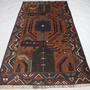 May include: A brown, blue, green and red patterned rug with a geometric design. The rug has a fringed border.