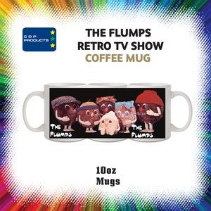 May include: White ceramic coffee mug with a black background featuring a group of brown, fuzzy characters with different hats and expressions. The text "The Flumps" is printed on the mug, along with the words "Retro TV Show" and "Coffee Mug". The mug is 10 ounces.