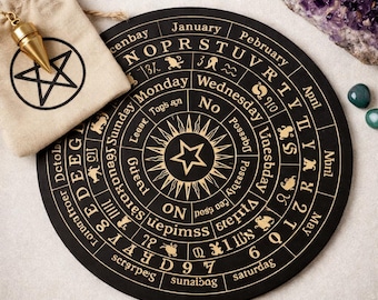 May include: A black divination board with gold lettering and a central star design. Includes a beige drawstring bag with a pentagram and a gold pendulum. Amethyst and green stones are also present.