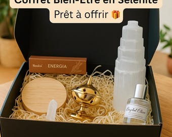 May include: A black gift box filled with straw, a selenite tower, a gold incense burner, a wooden coaster, a small crystal, a perfume bottle, and a box labeled "Energia". The box has text that reads "Coffret Bien-Être en Sélénite Prêt à offrir".