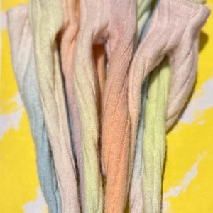 May include: A set of six pastel-colored ribbed socks with a gradient color effect. The socks are made of a soft, comfortable material and are perfect for adding a touch of color to any outfit.