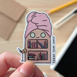 May include: A whimsical sticker featuring a bookshelf with a pink towel on its head and cucumber slices for eyes. The sticker includes a cocktail and the text "Treat Your Shelf". The bookshelf is filled with colorful books.