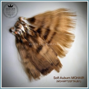 May include: A collection of soft auburn mohair hair bundles for doll making, featuring light brown and golden highlights. Each bundle is secured with a small elastic band at the top. The text reads Soft Auburn MOHAIR (MOHMPT2SFTAUB1).