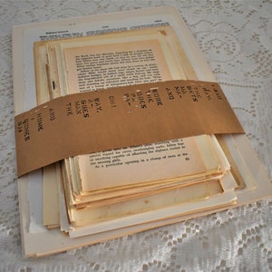 May include: A stack of vintage paper pages wrapped in brown paper with the text "AND THE MAN GOES AWAY" written on the paper.