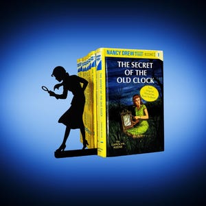May include: A bookend featuring a black silhouette of a woman with a magnifying glass, next to a stack of yellow and blue books. The book on the right is titled "The Secret of the Old Clock" by Carolyn Keene, with a vintage cover illustration.