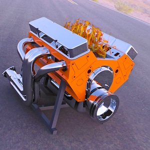 May include: A chrome and orange engine block with flames coming out of the exhaust ports. The engine is on a stand and is ready to be installed in a vehicle.
