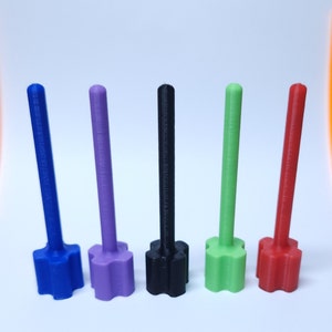 May include: Five plastic dowels with star-shaped bases in blue, purple, black, green, and red.