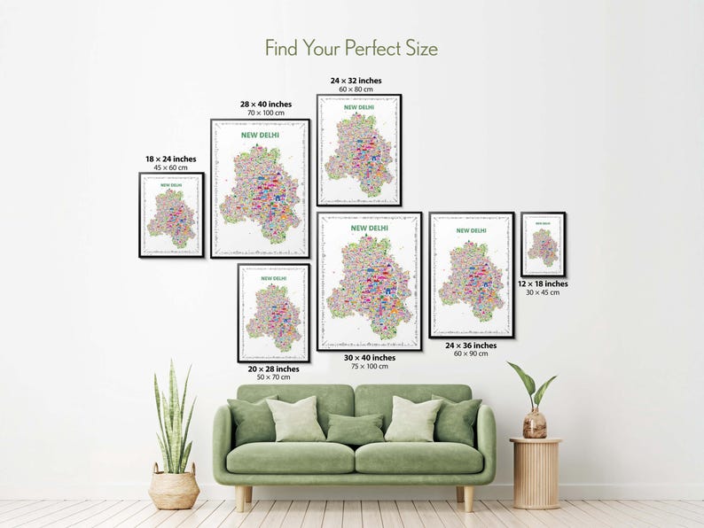Colorful New Delhi illustrated map poster size guide showing seven framed print sizes from 12 x 18 to 30 x 40 inches above a green sofa.