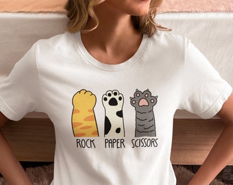 Rock, Paper, Scissors Cat Edition! Unleash fun on your tee! Multiple sizes & colors to match your style. Grab yours meow!