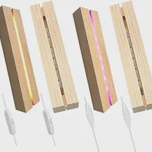 May include: Four rectangular wooden LED light bases with a slot for displaying items. Each base has a different colored light: yellow, white, and purple. Each base has a white power cord with an on/off switch.