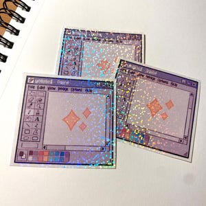 May include: Three holographic stickers depicting a retro computer paint program interface. The stickers have a light purple background with a toolbar on the left and text that reads "untitled - Paint". The stickers have a glittery, iridescent finish.