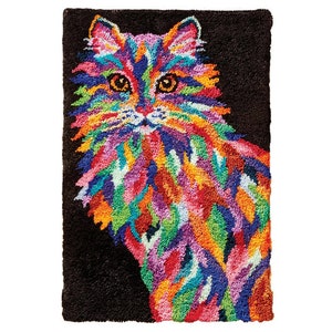 May include: A colourful, abstract rug featuring a cat with a black background. The cat is made up of various colours, including pink, blue, green, yellow, and orange.
