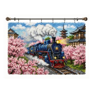 May include: A blue steam train with a gold star detail travels through a Japanese landscape. The scene includes pink cherry blossom trees, traditional buildings, and a pagoda. The artwork is displayed on a rod with decorative finials.