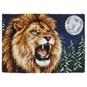 May include: A detailed rug depicts a roaring lion with a golden mane, set against a dark blue night sky. A full moon and snow-covered evergreen trees are in the background. The lion's mouth is open, revealing its teeth and pink tongue.