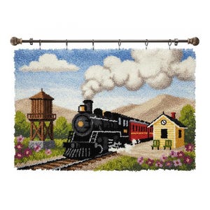 May include: A hand-stitched wall hanging showing a steam train. The black train with red carriages is on a track, passing a yellow station and water tower. The scene is set against a backdrop of mountains, clouds, and a blue sky.