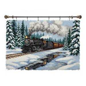 May include: A black steam train with brown carriages travels through a snowy landscape, with evergreen trees and a light blue sky. The image is a textile art piece, possibly a rug or wall hanging, and is mounted on a decorative rod.