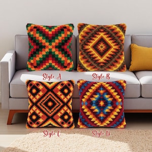 Könnte beinhalten: Vier dekorative Zierkissen mit geometrischen Mustern in verschiedenen Farben werden auf einem grauen Sofa präsentiert. Die Stile A, B, C und D sind unter jedem Kissen beschriftet. Die Kissen weisen ein strukturiertes, gewebtes Design auf und verleihen jedem Wohnraum einen gemütlichen und farbenfrohen Akzent.