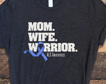 May include: Dark grey t-shirt with the text "MOM. WIFE. WARRIOR." and a blue ribbon with the text "ALS Awareness".